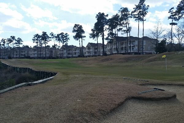 view of golf course with condo's in background